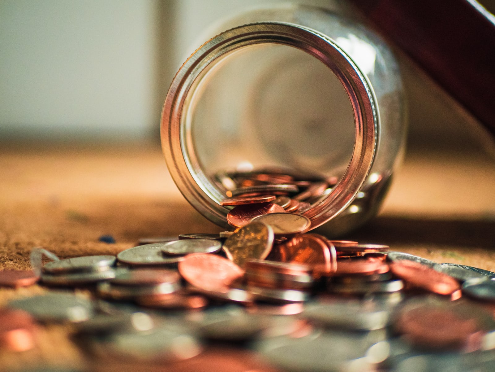 coins spilling out from a jar