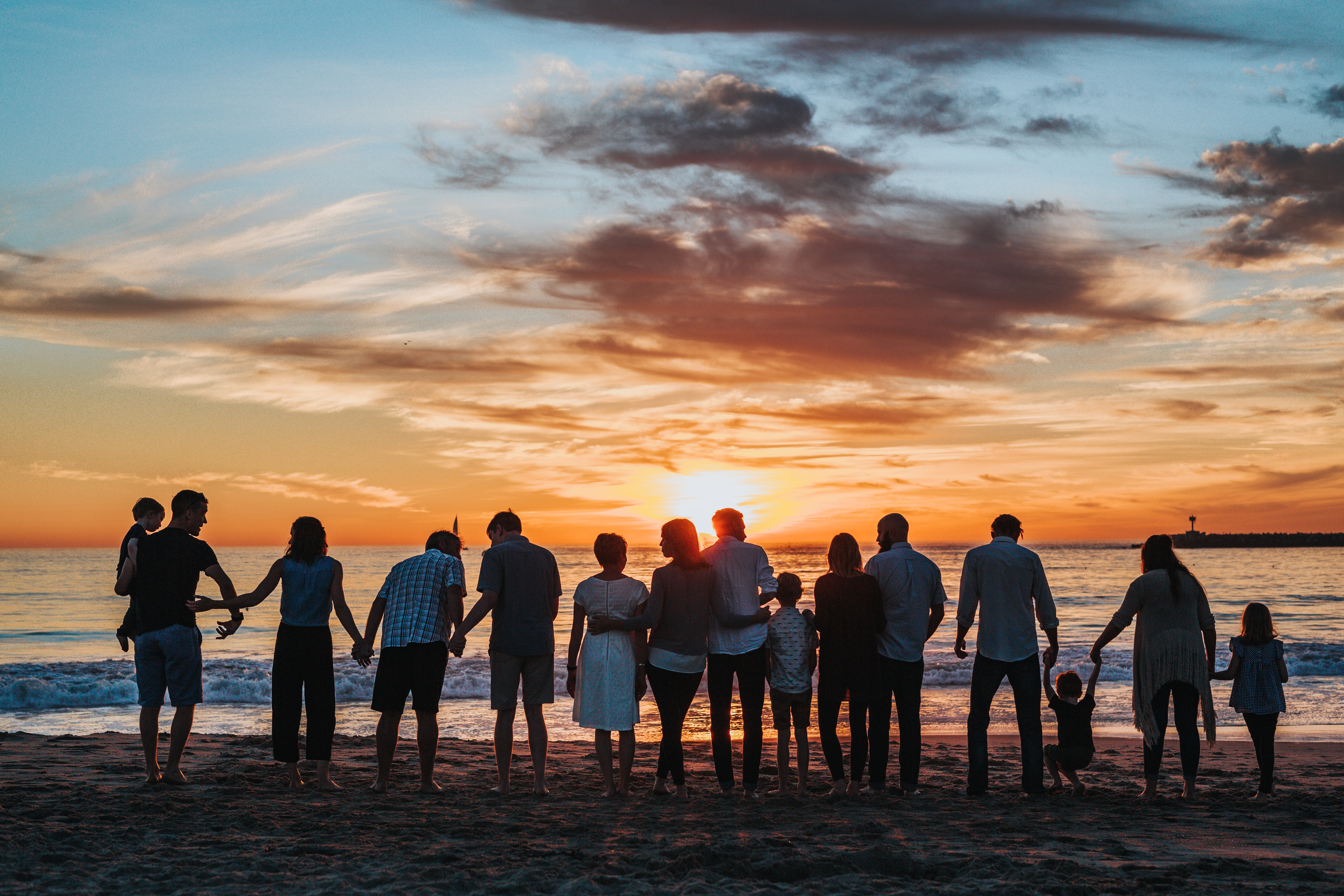 a large family facing the ocean
