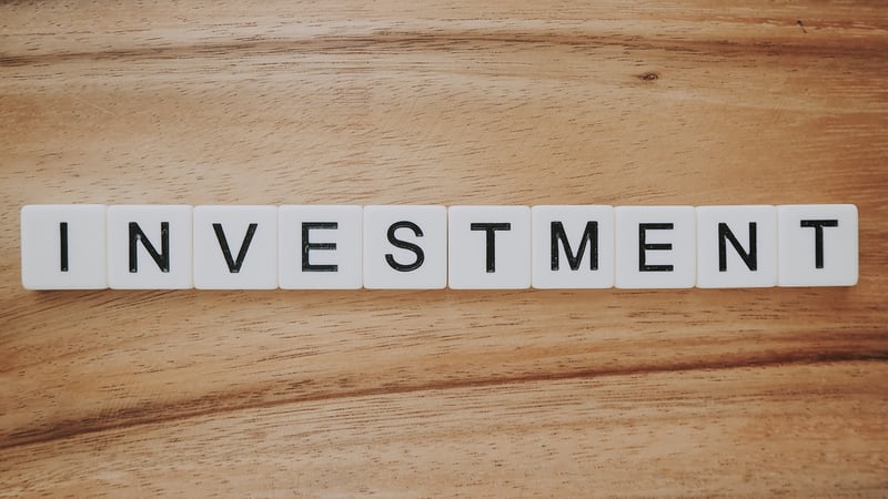 scrabble letters spelling out 'investment'