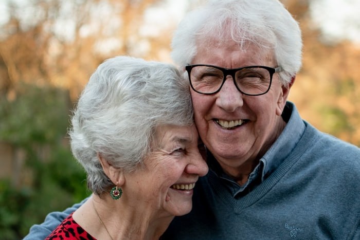 a retired couple embracing