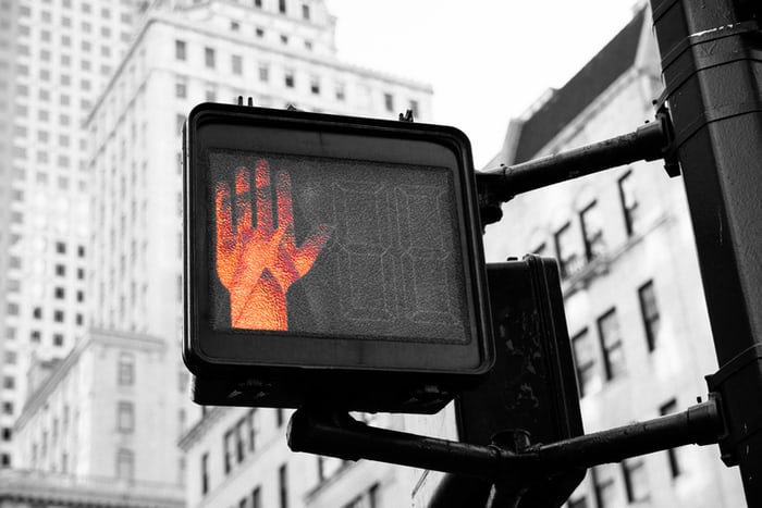 a pedestrian crossing light with the wait light lit